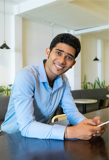 Young professional smiling at a cafe